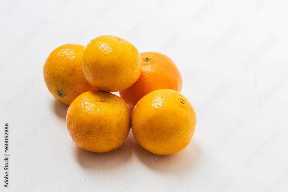 Small tangerines on a white background. Fruit for sale. Small tangerines on a white background. Fruit for sale.