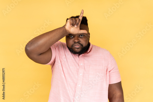Fotografija Portrait of upset disappointed man wearing pink shirt showing looser gesture with hand on forehead, having financial and business problems