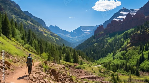 A woman trekking in the Uncompahgre National Forest near Ouray, Colorado's Bear Creek National Recreation Trail. photo