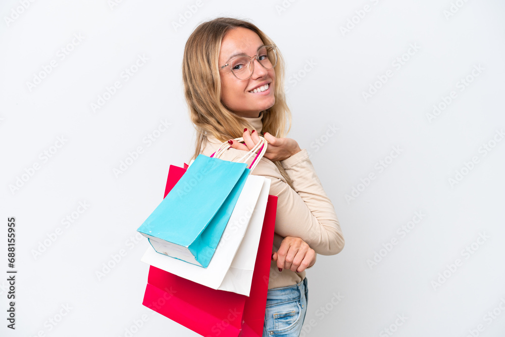 Young Russian woman isolated on white background holding shopping bags and smiling Young Russian woman isolated on white background holding shopping bags and smiling