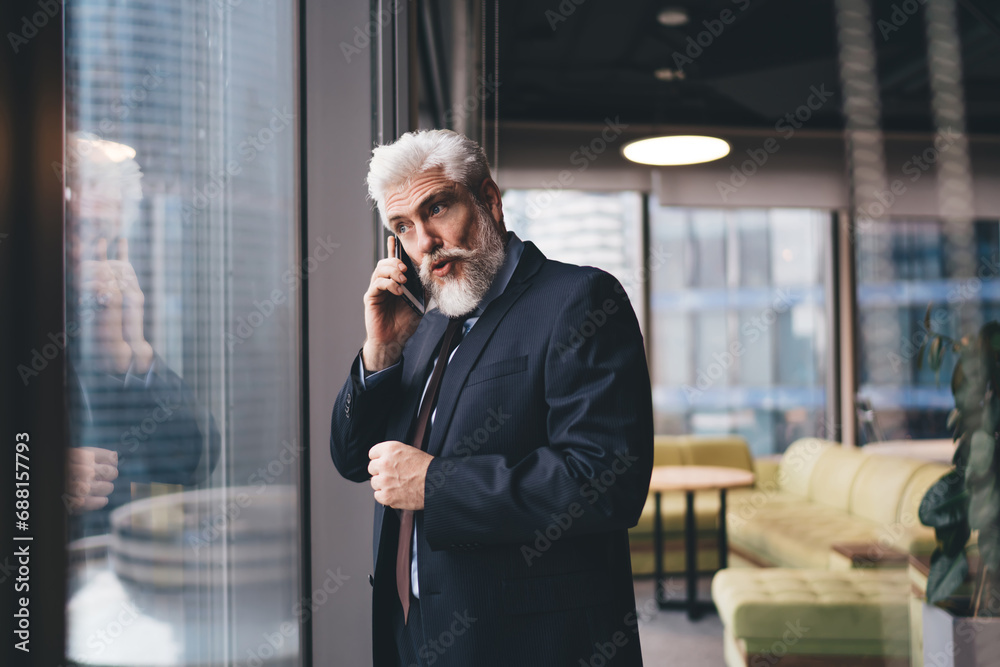 Senior entrepreneur having phone conversation Senior entrepreneur having phone conversation