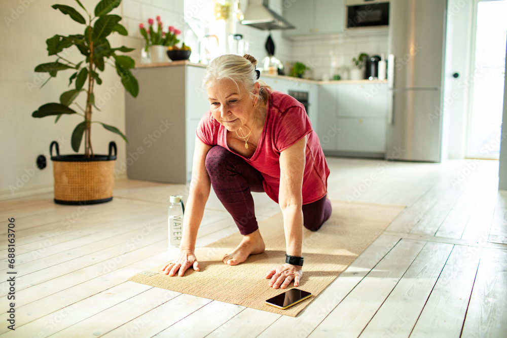 Senior woman doing home yoga practice Senior woman doing home yoga practice