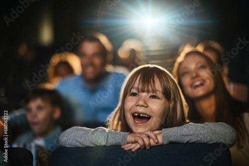 Girl watching a film in movie theater photo