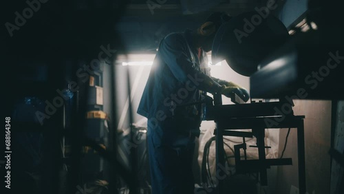 A worker works with parts in a metalworking shop. Metal works in factory. Concept of profession, factory mechanisms, technology, manufacture. Cinematic shot, 4K photo