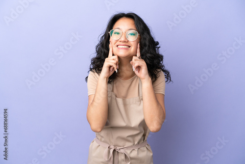 Restaurant asian waiter isolated on purple background smiling with a happy and pleasant expression