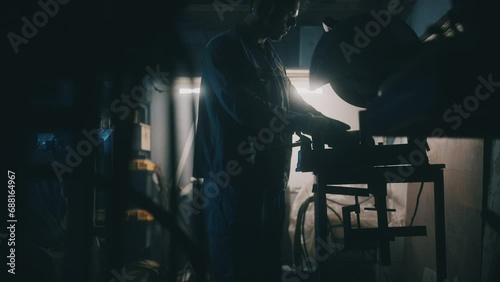A worker works with parts in a metalworking shop. Metal works in factory. Concept of profession, factory mechanisms, technology, manufacture. Cinematic shot, 4K photo