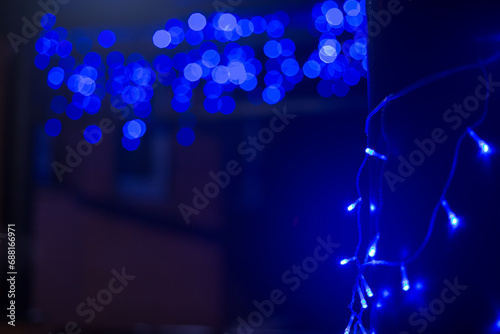 Blue glowing Christmas lights outside.