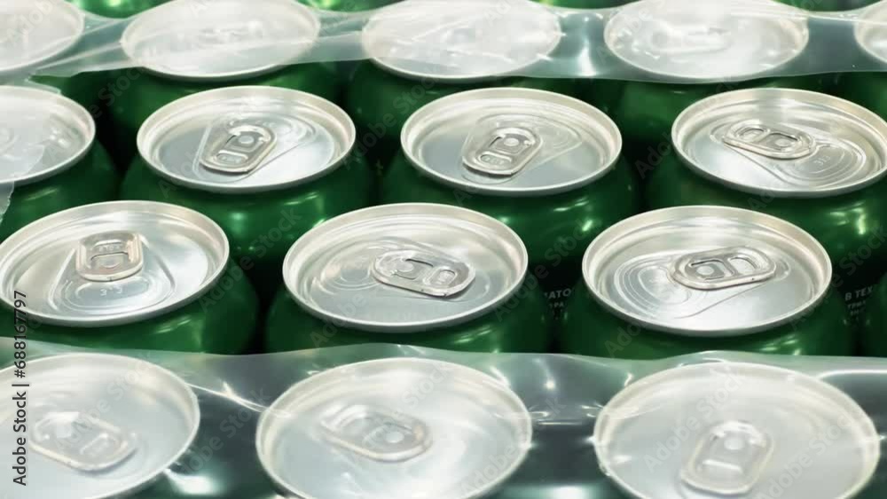 Tin cans of beer stand in rows on the warehouse or wholesale store shelf Tin cans of beer stand in rows on the warehouse or wholesale store shelf