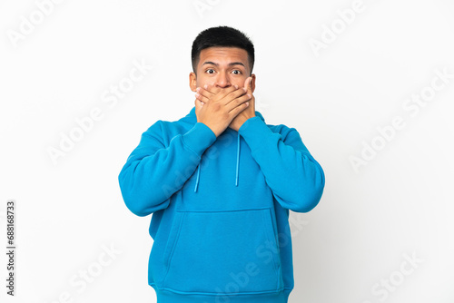 Young Ecuadorian man isolated on white background covering mouth with hands