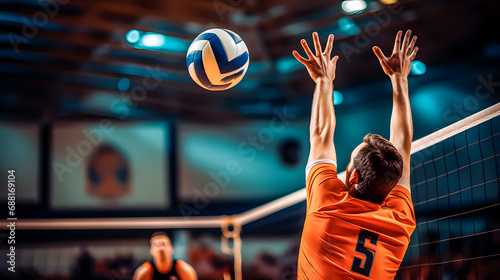 Male volleyball player reaching for ball with hands photo