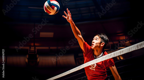 Asian volleyball player spiking over the net