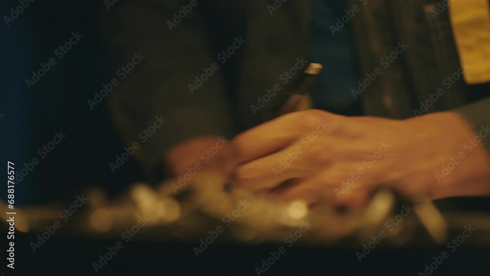 Hands of male engineer works with drawings lying sketch on steel table in dark workshop, using a pen. Drawing indoors on new product prototype. Close up. Shot on RED Cinema Camera in 4K
