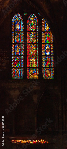 Antique stained glass window and candles light in Saint Stephen cathedral of Metz, France. 