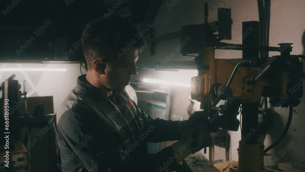 A worker works on a metal drilling machine in a workshop. Metallurgy production. A machinist operating a traditional non-CNC milling machine in a machine shop. Operates an industrial machine. 4K A worker works on a metal drilling machine in a workshop. Metallurgy production. A machinist operating a traditional non-CNC milling machine in a machine shop. Operates an industrial machine. 4K