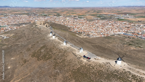 Aerial view of the traditional mills of Consuegra in Toledo, Spain. Forming a line to a castle with the town in the background
