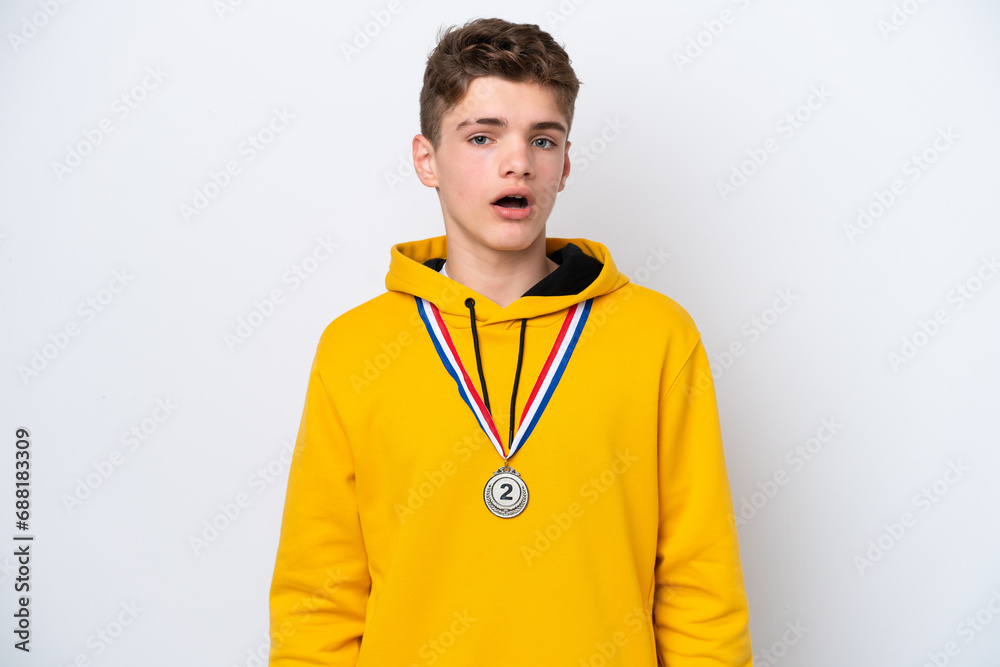 Teenager Russian man with medals isolated on white background with surprise facial expression Teenager Russian man with medals isolated on white background with surprise facial expression