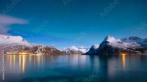 Norway, Lofoten island. Mountains and reflections on water at night. Winter landscape. The sky with stars and Aurora borealis. Nature as a background. North travel. © biletskiyevgeniy.com