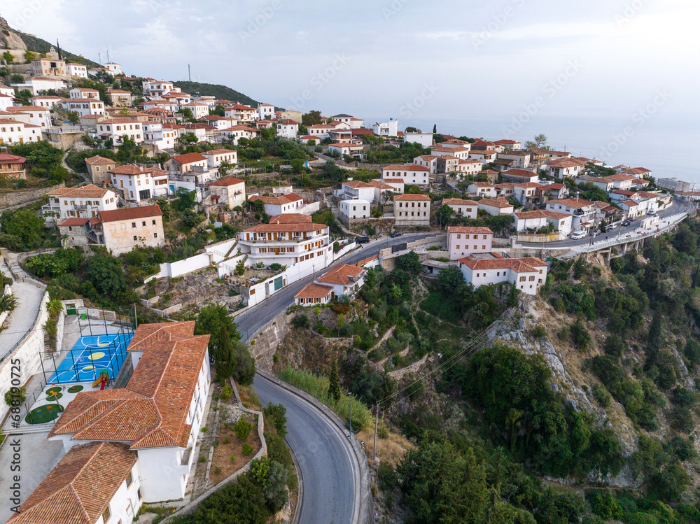 Dhermi at Sunset time. Aerial Shot of Beautiful Village Sea View, Stone Houses, beach Resort in Mountains of Albania