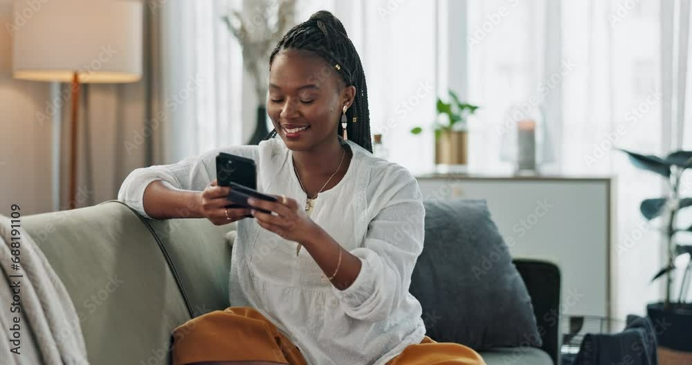 Home, credit card and black woman on a couch, smartphone and connection with payment, online shopping and smile. African person, apartment or girl on sofa, cellphone or transaction with investment