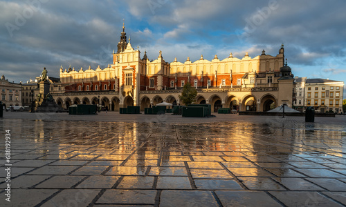 Renaissance Cloth Hall on Krakow Main Square reflecting in the wet cobblestones, sunny morning, Cracow, Poland