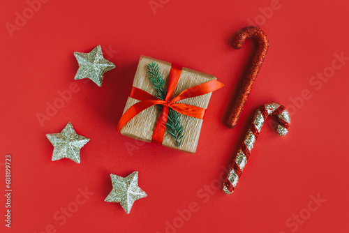 Gift box with Christmas ornaments on a red background. Holiday concept.