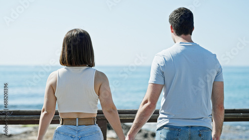 Beautiful couple standing backwards with hands together at seaside © Krakenimages.com