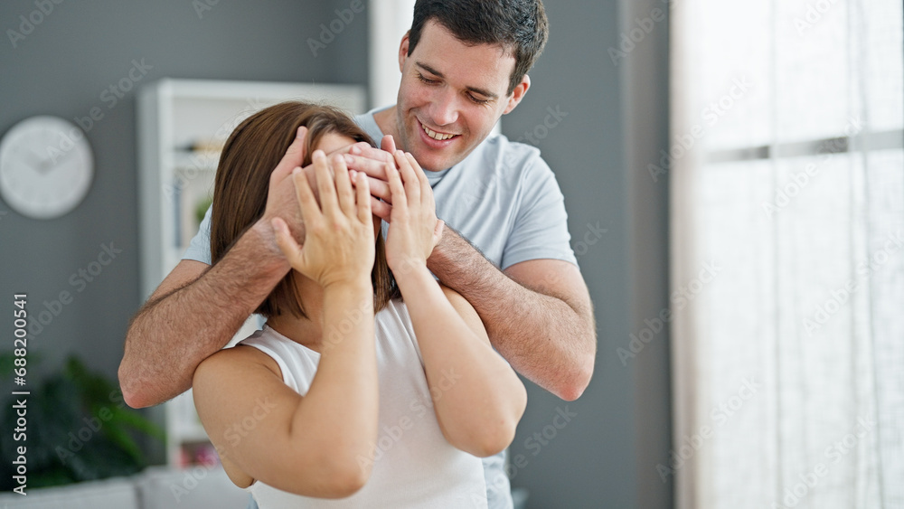 Beautiful couple surprise covering eyes with hands at home Beautiful couple surprise covering eyes with hands at home