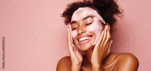 a smiling woman on pink background with hands touching her face,
