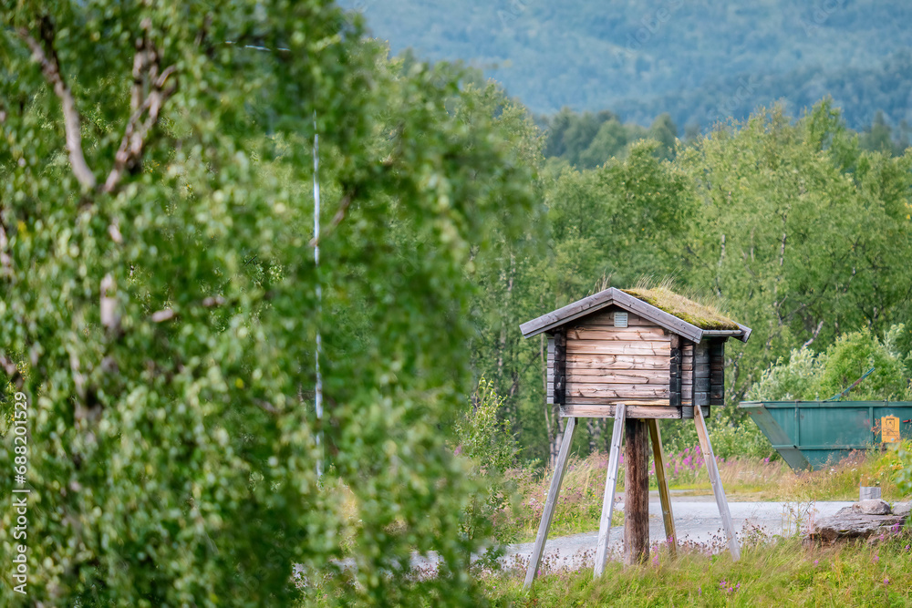 A traditional Sami storage shed is built on pole to keep animals out. Sweden, Lapland. The Sami are the traditionally Sámi-speaking peoples inhabiting the region of Sapmi A traditional Sami storage shed is built on pole to keep animals out. Sweden, Lapland. The Sami are the traditionally Sámi-speaking peoples inhabiting the region of Sapmi
