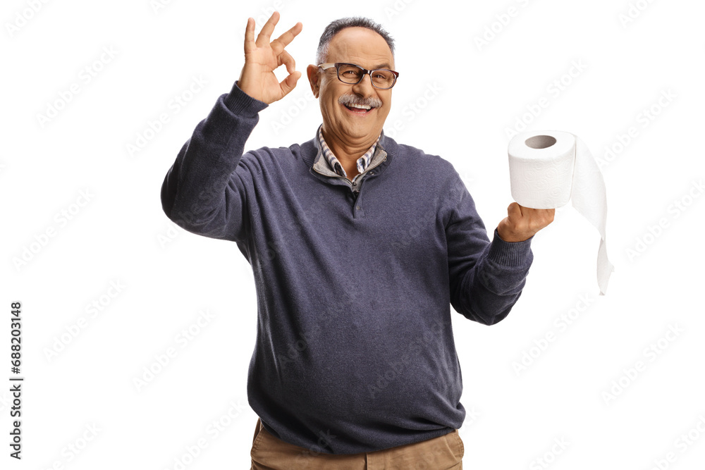Smiling mature man holding a toilet paper roll and gesturing ok sign Smiling mature man holding a toilet paper roll and gesturing ok sign