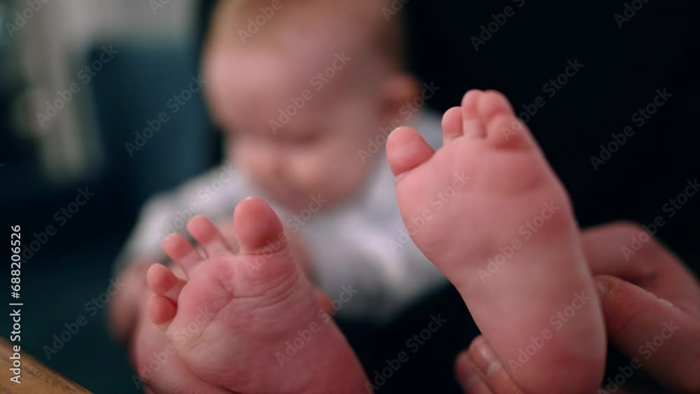 Father's hands hold the tiny bare feet of his son. Little baby boy in dad's arms. Close up. Father's hands hold the tiny bare feet of his son. Little baby boy in dad's arms. Close up.