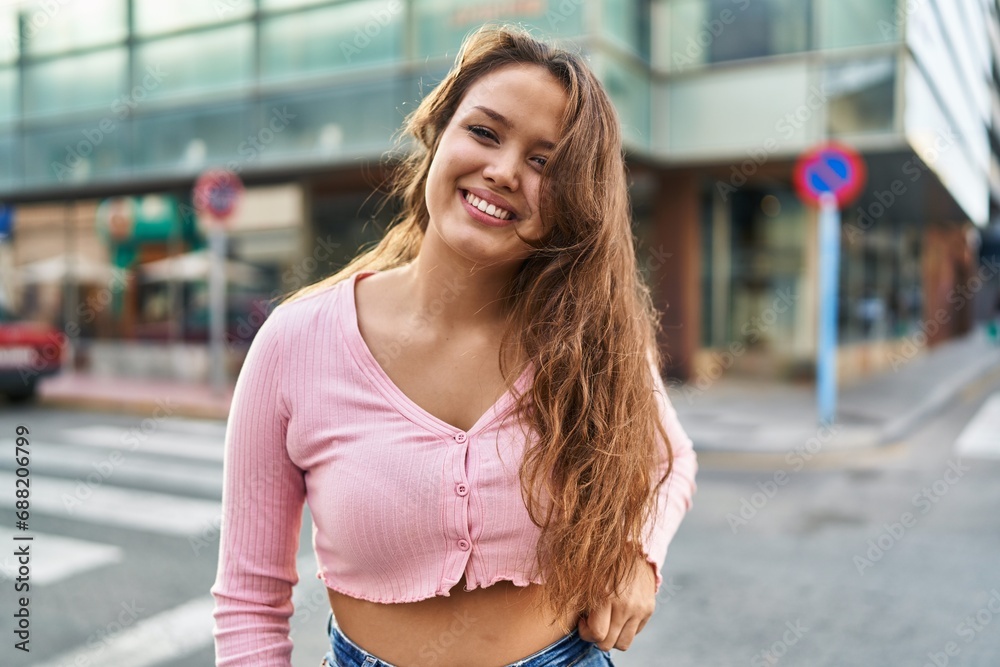 Young beautiful hispanic woman smiling confident standing at street