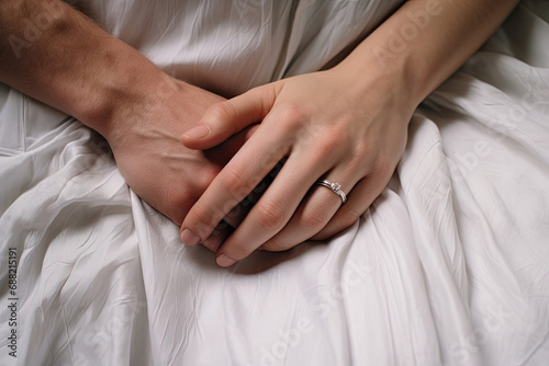 An intimate close-up of a male and female hand holding each other, symbolizing love and togetherness.