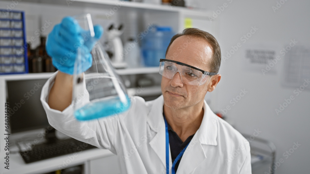 Handsome middle-aged man, a devoted scientist, meticulously measuring liquid in a test tube at his professional lab, epitome of safety and concentration