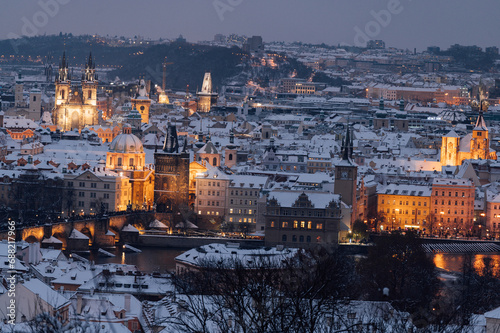 A winter evening enchants Charles Bridge and the cityscape of Prague. Prague, Czech Republic