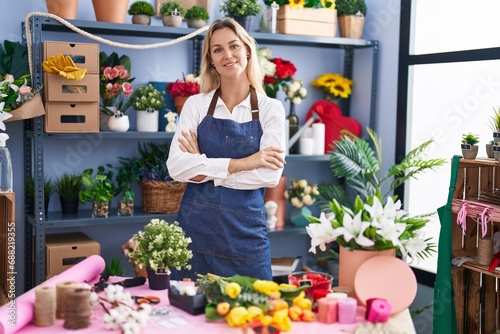 Young blonde woman florist smiling confident standing with arms crossed gesture at florist