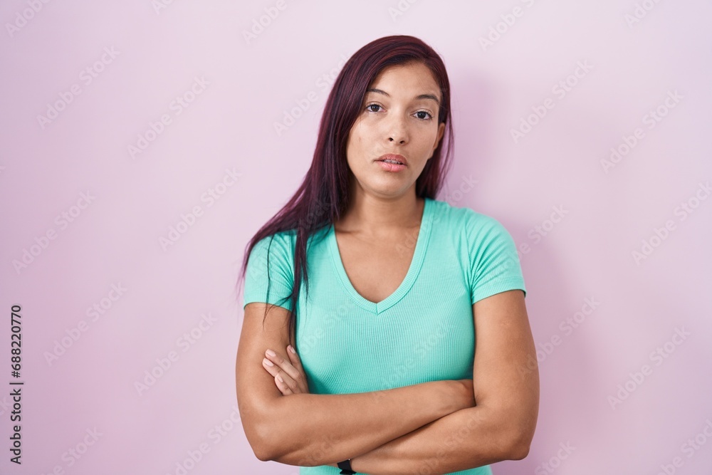 Young hispanic woman standing over pink background looking sleepy and tired, exhausted for fatigue and hangover, lazy eyes in the morning. Young hispanic woman standing over pink background looking sleepy and tired, exhausted for fatigue and hangover, lazy eyes in the morning.