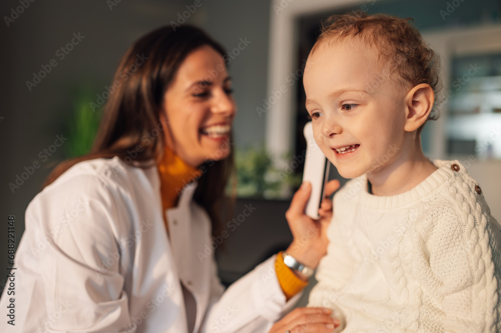 Portrait of a little boy smiling during doctor's visit at home. Portrait of a little boy smiling during doctor's visit at home.
