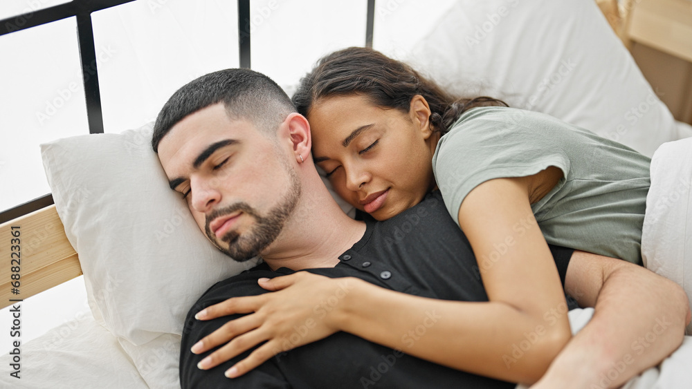 Beautiful couple in love hugging each other, lying comfortably on bed in cozy bedroom, relishing the relaxing morning sleep together Beautiful couple in love hugging each other, lying comfortably on bed in cozy bedroom, relishing the relaxing morning sleep together