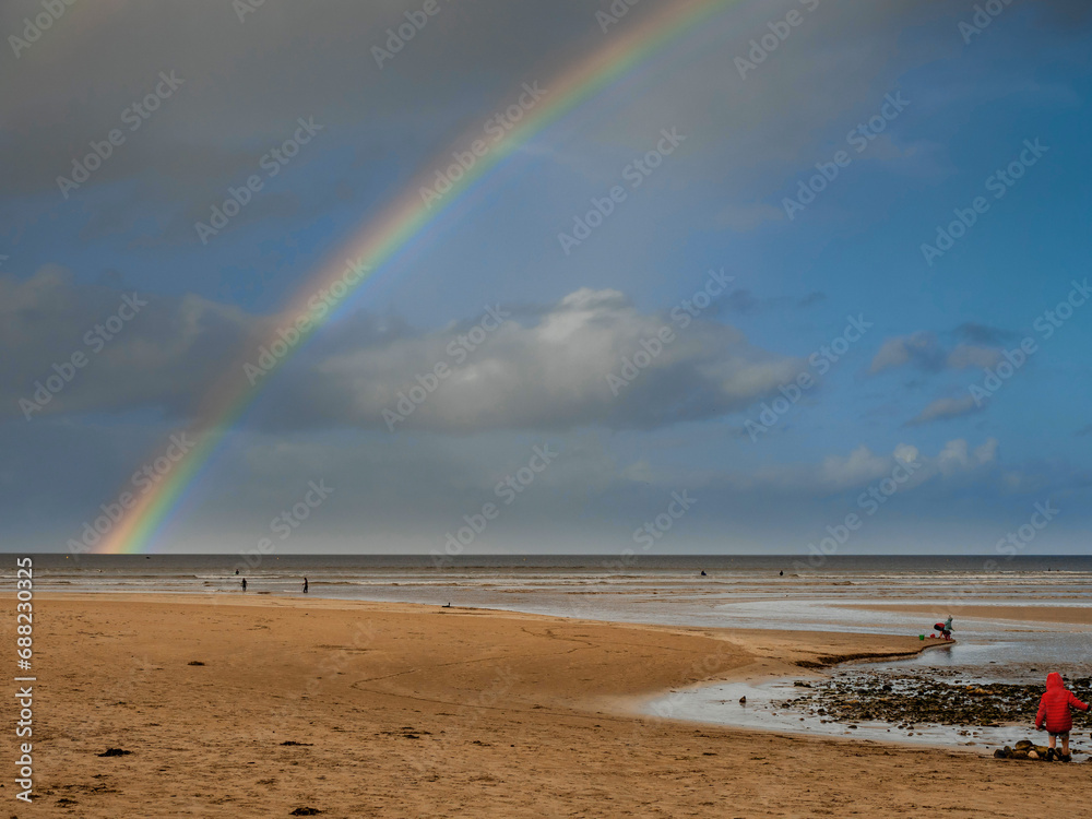 Nature scene with beach, ocean and cloudy sky with rainbow. Rich saturated colors. Nature wonder scene. West of Ireland. Nature scene with beach, ocean and cloudy sky with rainbow. Rich saturated colors. Nature wonder scene. West of Ireland.