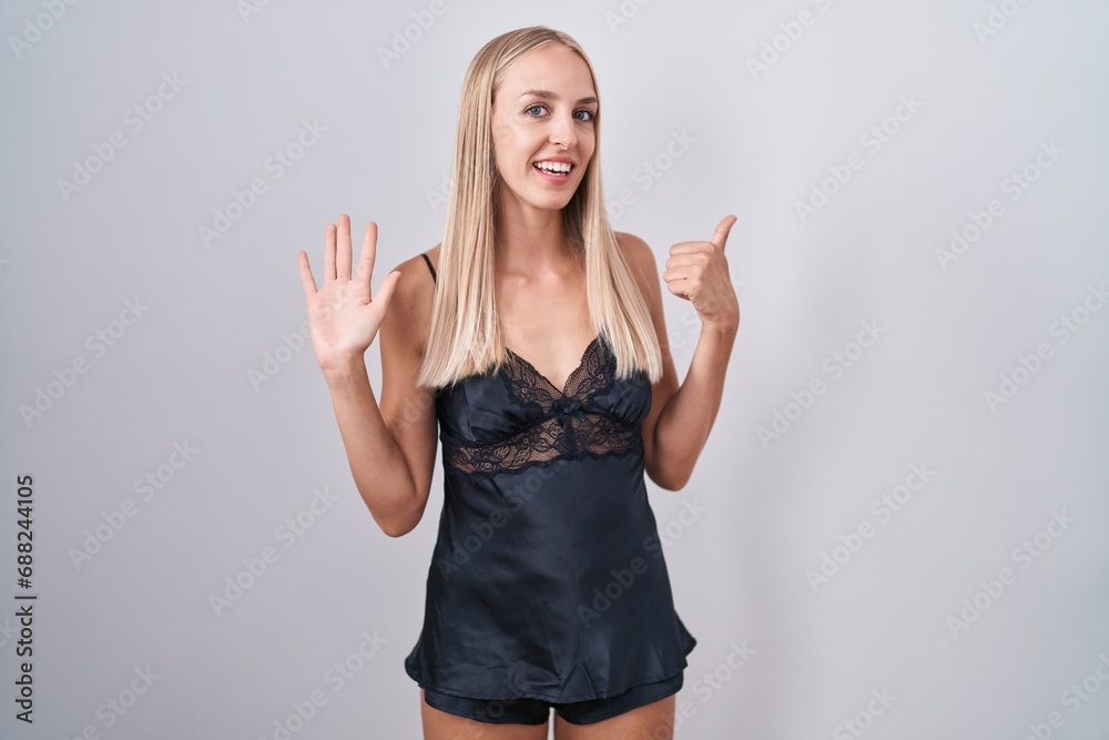 Young caucasian woman wearing nightgown showing and pointing up with fingers number six while smiling confident and happy. Young caucasian woman wearing nightgown showing and pointing up with fingers number six while smiling confident and happy.
