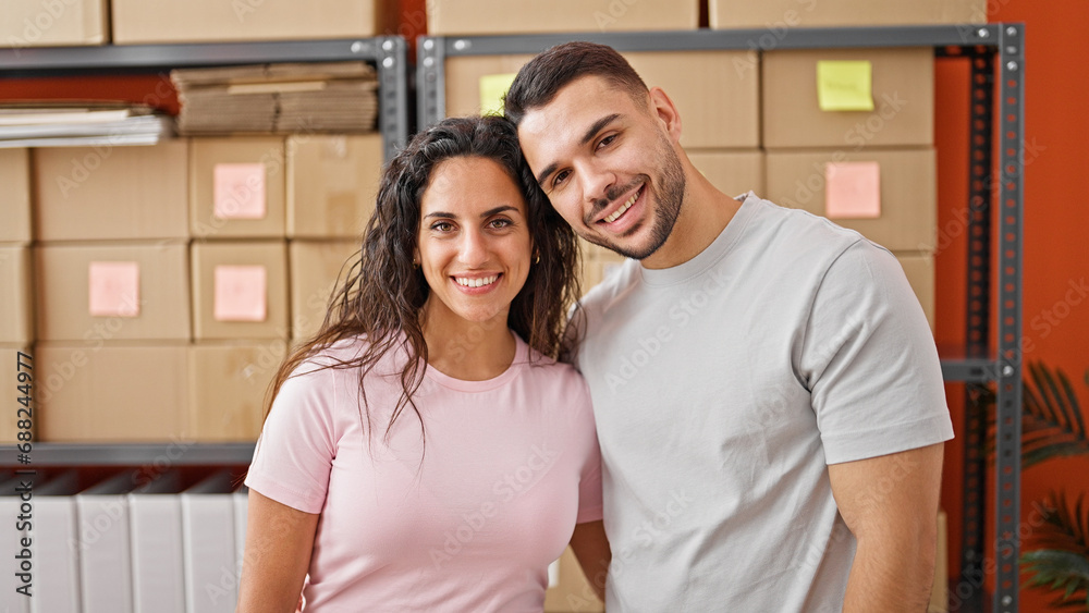 Man and woman ecommerce business workers hugging each other smiling at office Man and woman ecommerce business workers hugging each other smiling at office