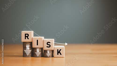 business, finance, low risk investment, Risk Management, Risk wording on decreasing coins stacking with down arrow for financial banking risk analysis and management ,Low risk low return concept. photo