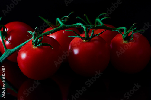 Cherry tomatoes on a black background.