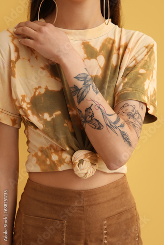 Young woman with tattooed a...