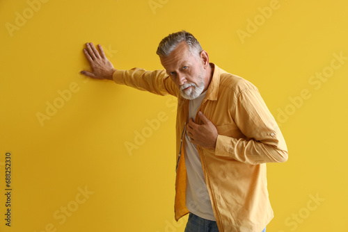Mature man having heart att...