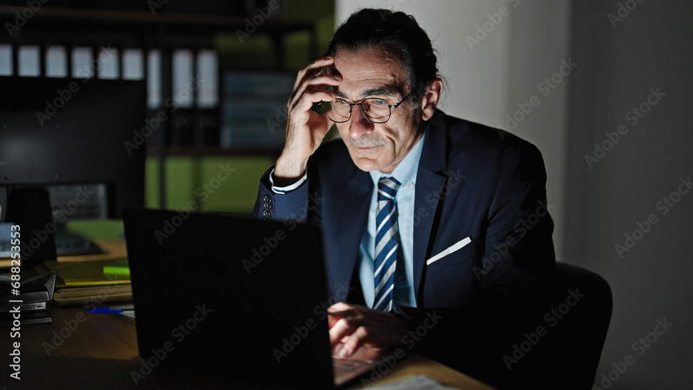 Middle age man business worker using laptop working at the office Middle age man business worker using laptop working at the office