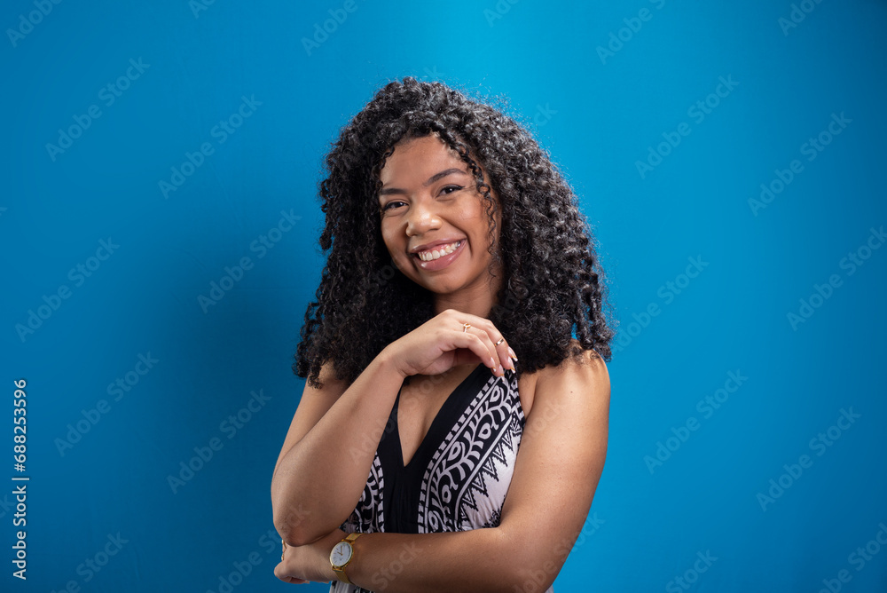 Beautiful young woman with curly hair looking at the camera Beautiful young woman with curly hair looking at the camera