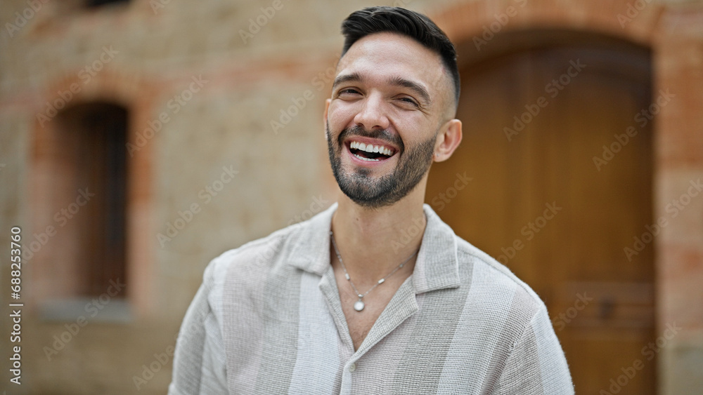 Young hispanic man smiling confident standing at street Young hispanic man smiling confident standing at street