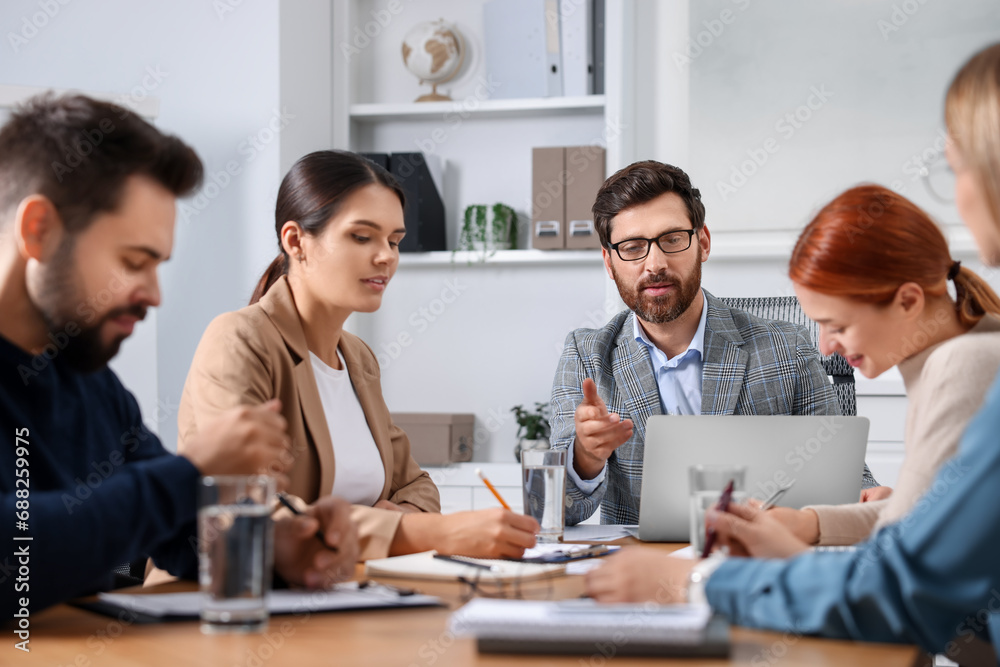 Team of employees working together in office Team of employees working together in office